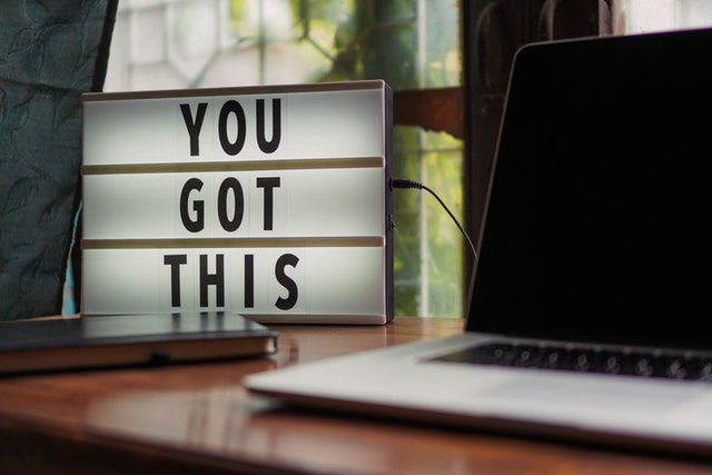 "you got this" motivational text next to laptop